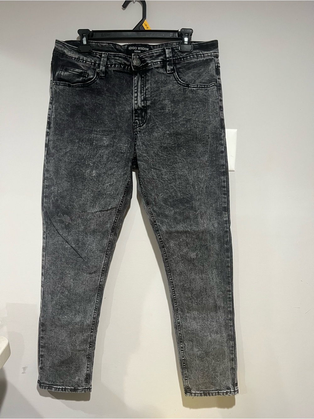 Indigo Wisdom Denim jeans featuring a bold black-and-grey acid wash finish.